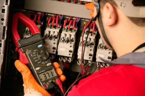 Electrician checking electrical panel