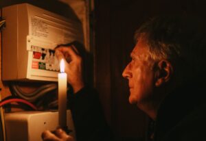 Man checking fuse box during blackout