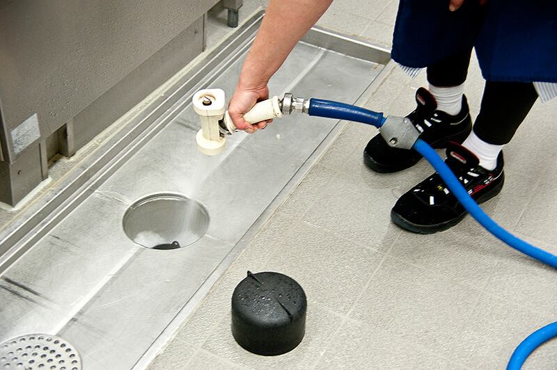 A person uses a hose to fill a sink, showcasing a water jetting service in Denver, CO