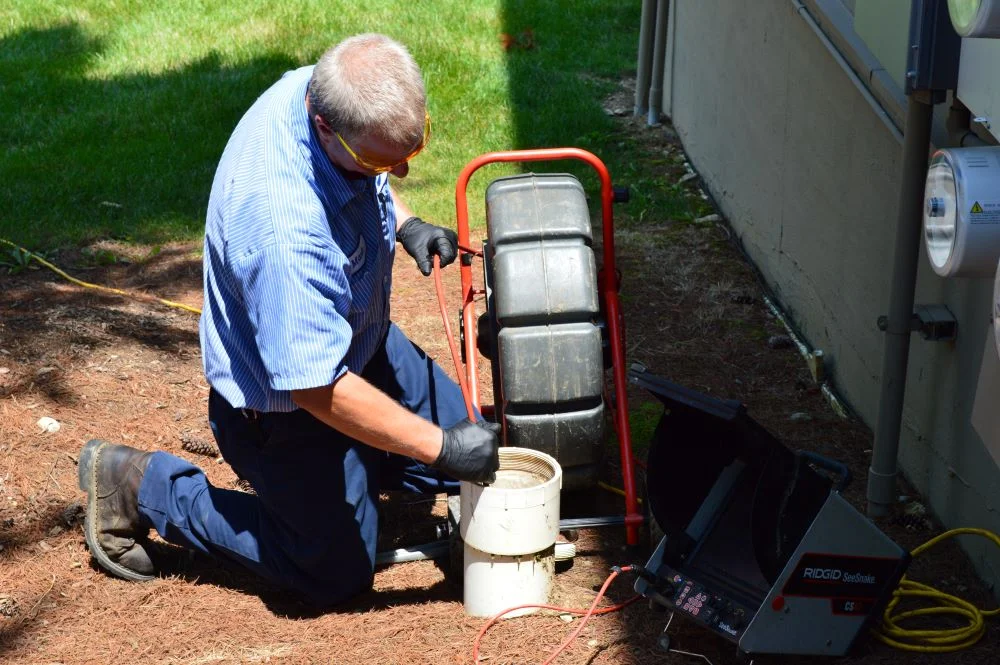 A woman sits on a couch, considering AC inspection and unit replacement in Fort Collins, CO