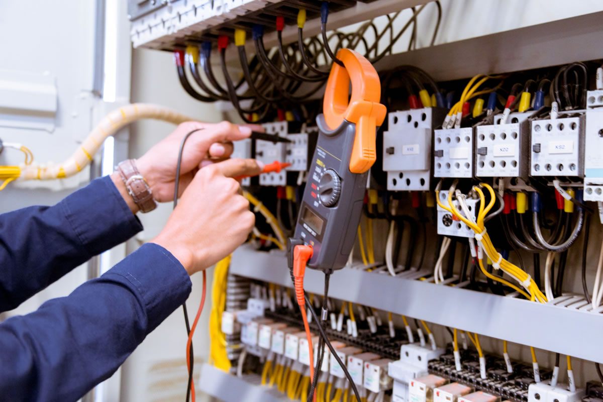 A technician in Fort Collins, CO, works on electrical equipment for service and lighting repair