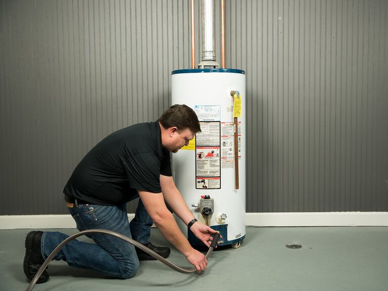 A woman sits on a couch, considering AC inspection and unit replacement in Fort Collins, CO
